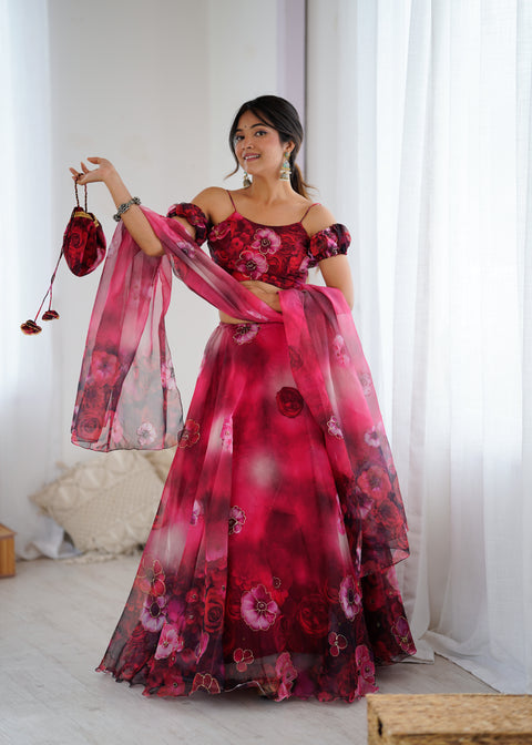 Woman wearing a red floral dress holding a matching handbag indoors.